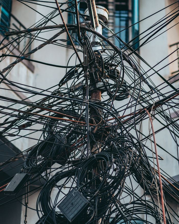Mastering the First Impression: Your intriguing post title goes here Chaotic tangle of electricity wires on an urban street utility pole, showcasing urban infrastructure.